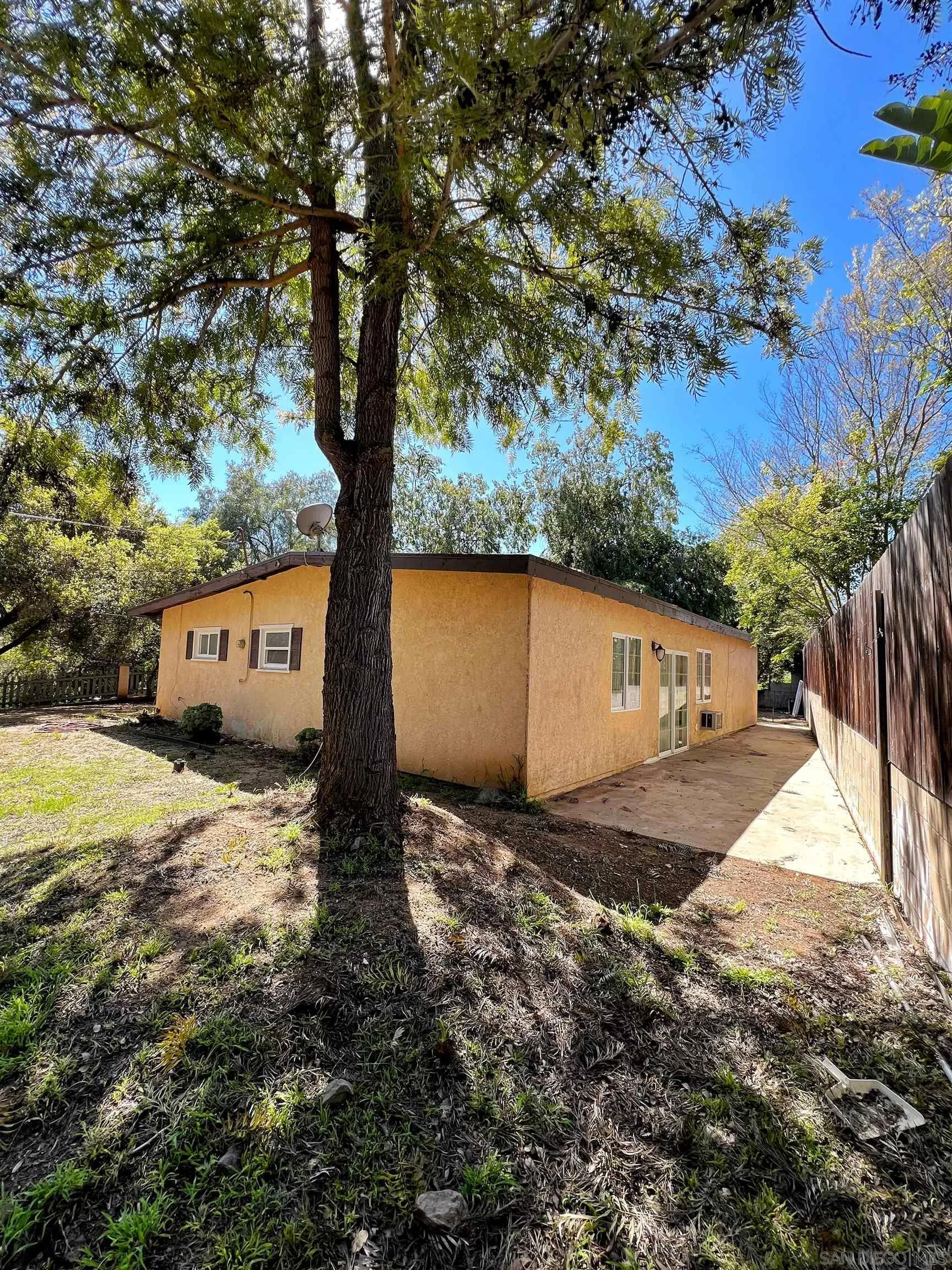 714 Convertible Lane Fallbrook, CA 92028 - Photo 2 of 28 a view of a large tree in front of a house