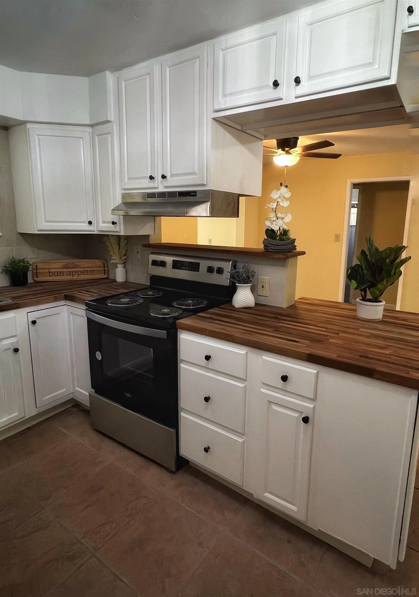 714 Convertible Lane Fallbrook, CA 92028 - Photo 7 of 28 a kitchen with granite countertop white cabinets and white appliances