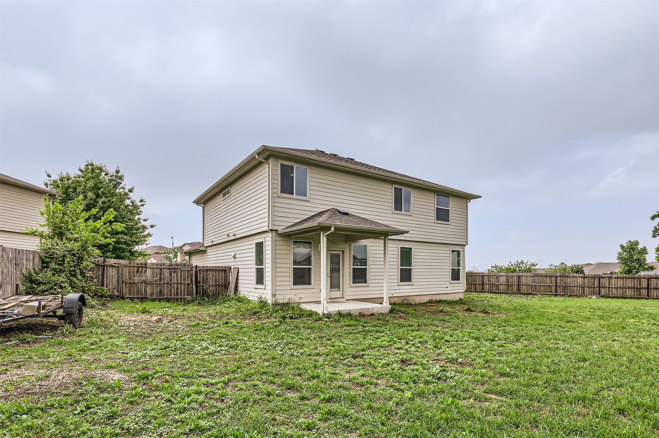 131 Lavaca Loop Hutto, TX 78634 - Photo 25 of 29 A spacious backyard with a private covered patio awaits outdoor enjoyment.