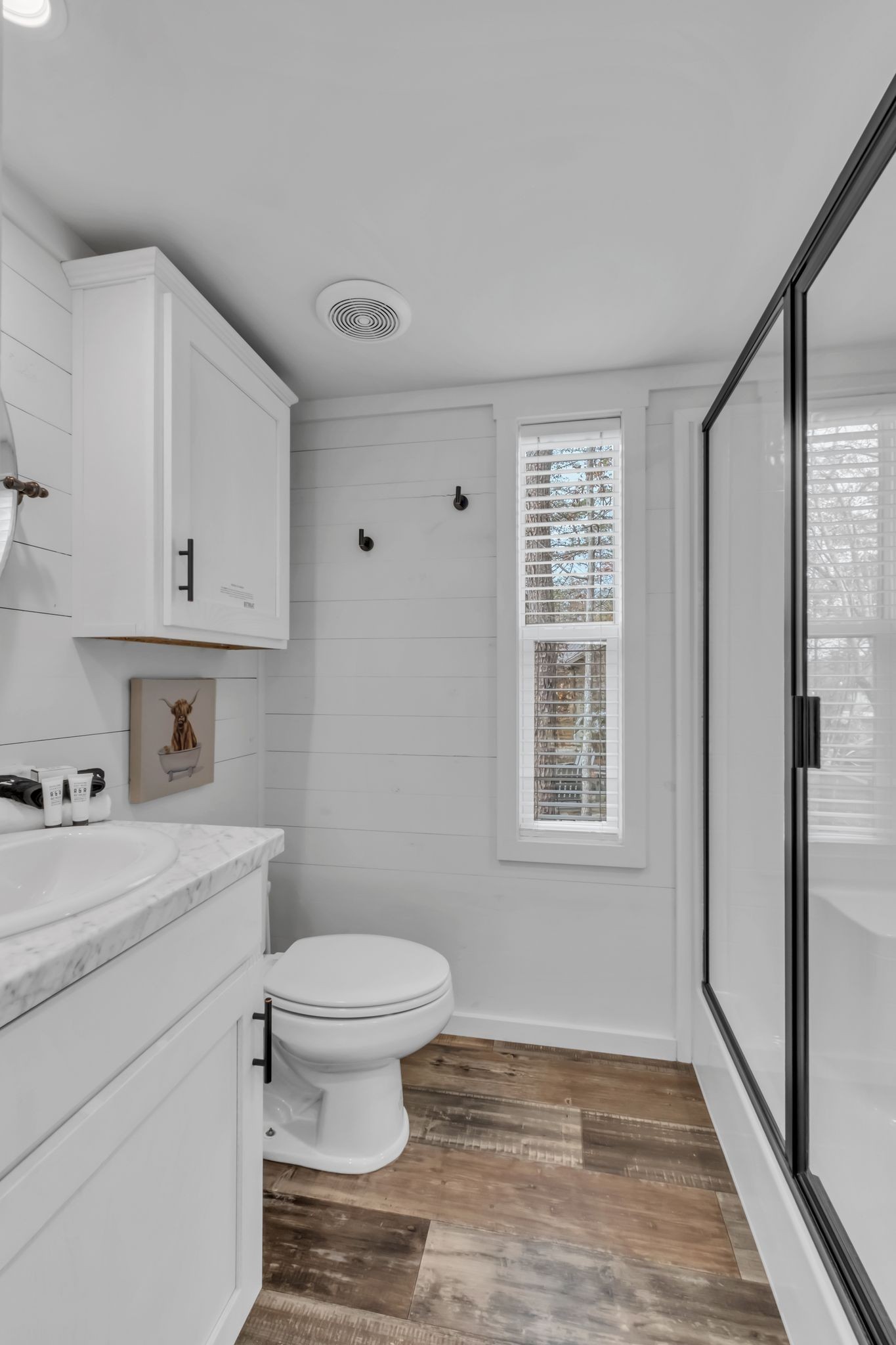 672 Waters Edge Way Tracy City, TN 37387 - Photo 13 of 81 a bathroom with a granite countertop toilet a sink a mirror and a window