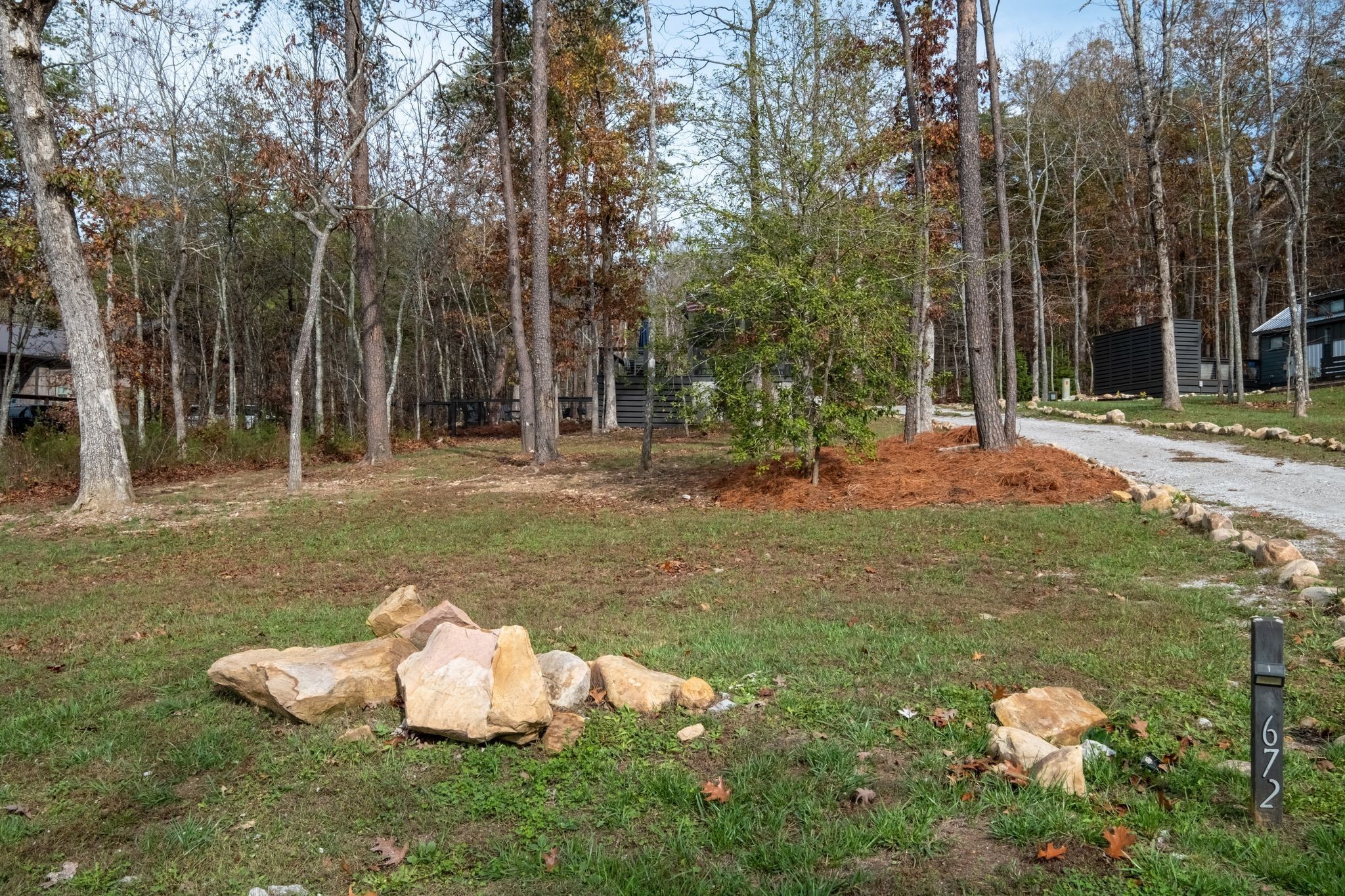 672 Waters Edge Way Tracy City, TN 37387 - Photo 44 of 81 a backyard of a house with lots of green space and trees