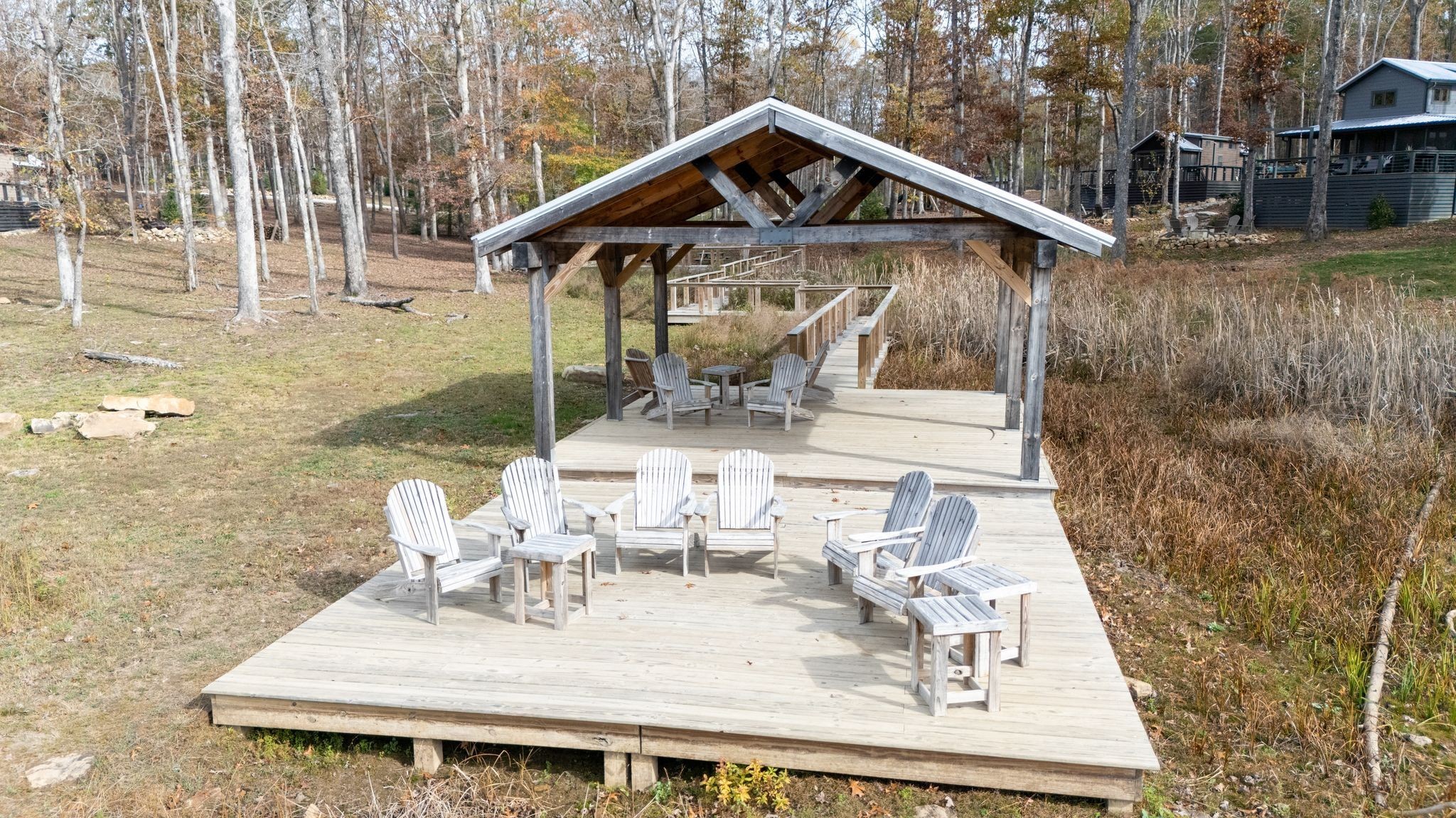 672 Waters Edge Way Tracy City, TN 37387 - Photo 71 of 81 a view of a patio with table and chairs with wooden floor and fence