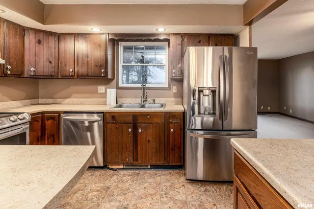 a kitchen with a stove sink and cabinets