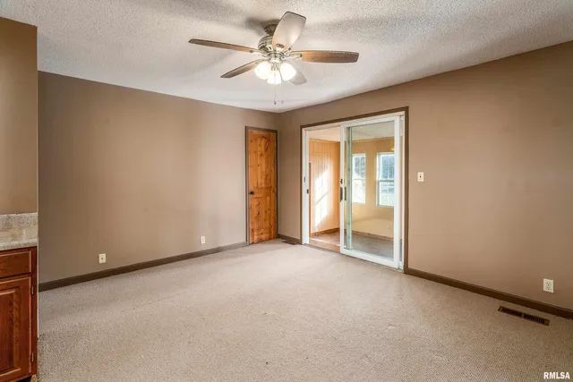 a view of a room with wooden floor and windows