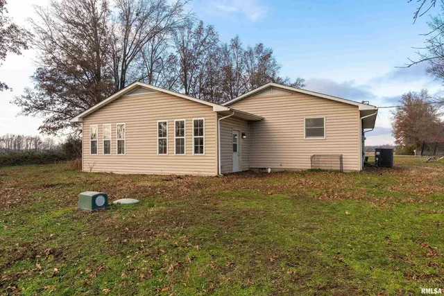 a backyard of a house with table and chairs