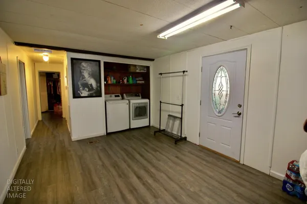 a view of a hallway with wooden floor and windows