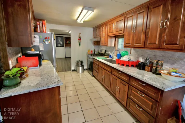 a kitchen with stainless steel appliances granite countertop sink stove and cabinets