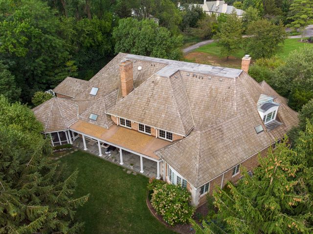 an aerial view of a house with a yard