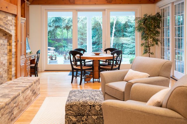 a living room with furniture a flat screen tv and entryway