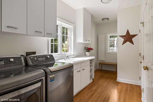 a spacious bedroom with a bed and a chandelier
