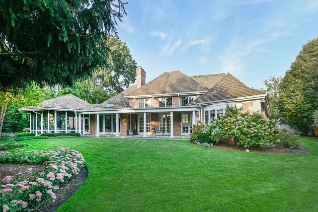 an aerial view of a house with garden space and street view