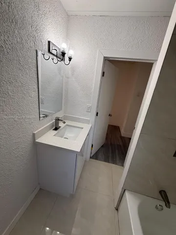 a bathroom with a sink and mirror