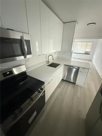 a kitchen with granite countertop a stove and a sink