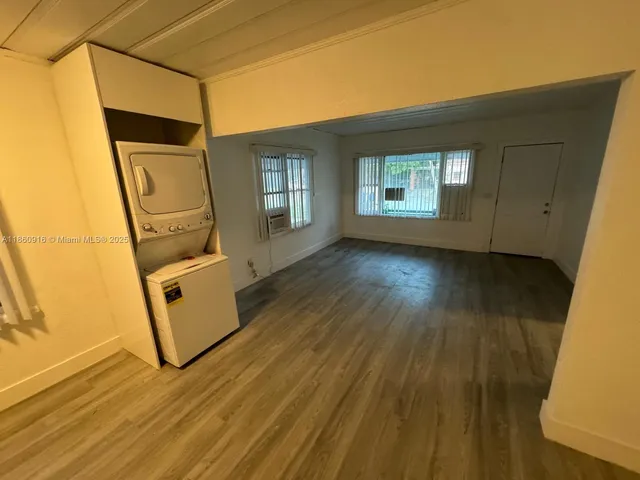 a view of a room with wooden floor and windows