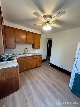 a kitchen with stainless steel appliances wooden cabinets and a stove top oven