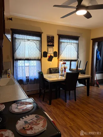 a living room with furniture and a view of kitchen