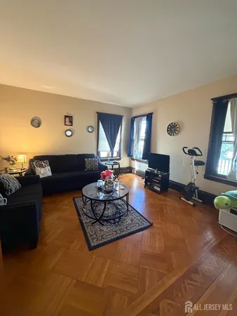 a living room with furniture rug and window