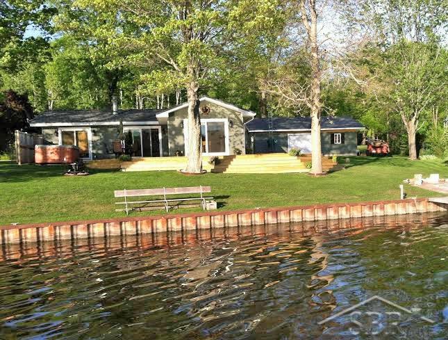 3072 South Whitney Beach Road Beaverton, MI 48612 - Photo 17 of 21 From the water you can see the new steel sea wall. Water is typically around 2 feet deep at the sea wall. Nice flat yard to enjoy.