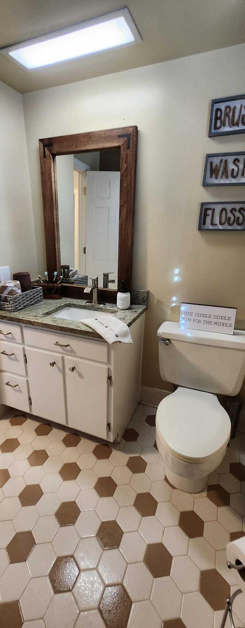 5257 North Spring Drive Northwest Roanoke, VA 24019 - Photo 32 of 47 a bathroom with a toilet a sink and a mirror