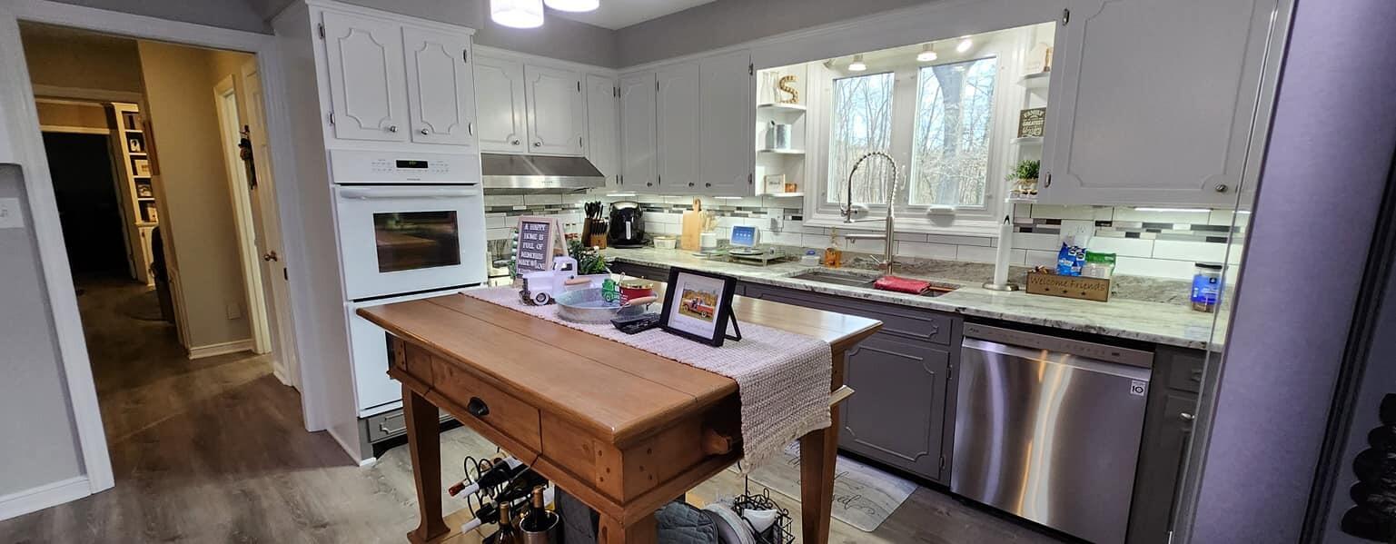 5257 North Spring Drive Northwest Roanoke, VA 24019 - Photo 7 of 47 a kitchen with stainless steel appliances a sink a table and chairs