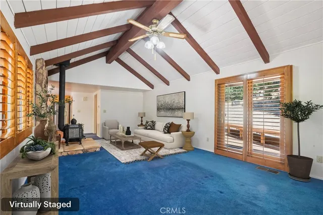 a living room with furniture and floor to ceiling window