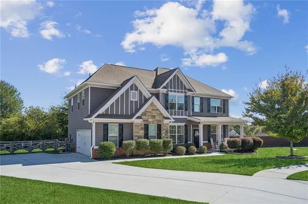 a front view of house with yard and green space