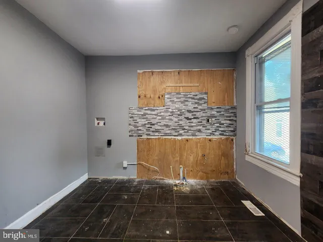 a room with wooden floor and windows