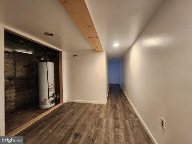 a view of hallway with wooden floor