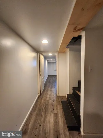 a view of hallway with wooden floor