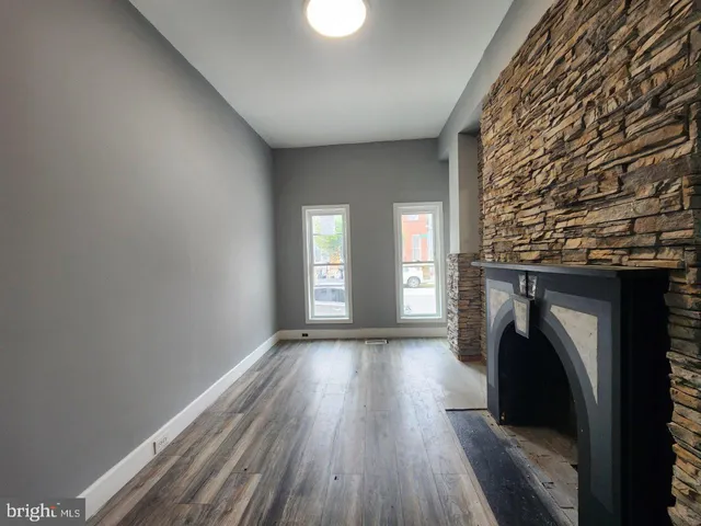a view of a livingroom with a fireplace and a window
