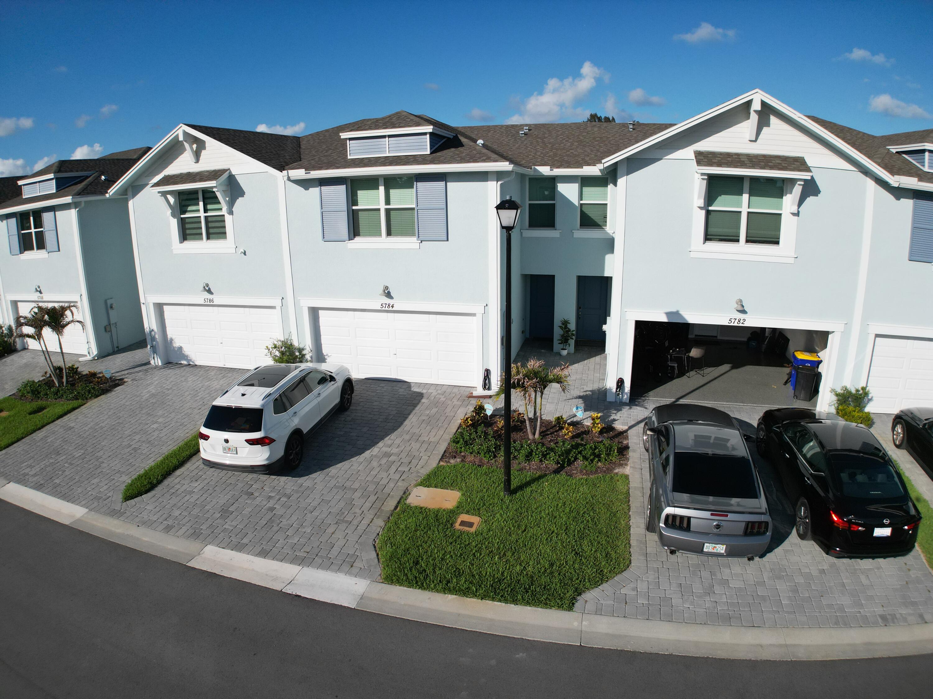 5784 Southeast Edgewater Circle Stuart, FL 34997 - Photo 22 of 33 a front view of a house with a yard