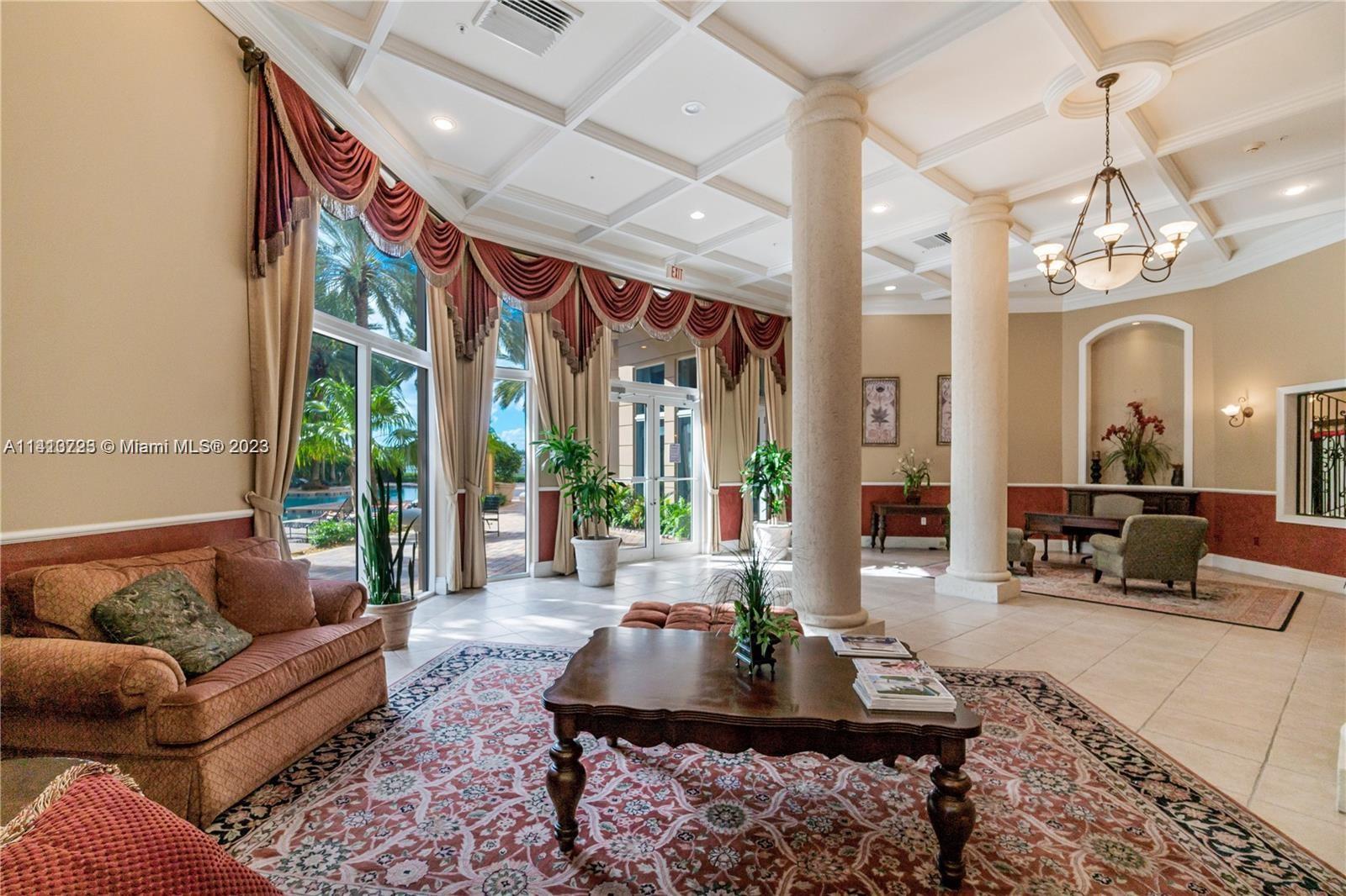 17100 North Bay Road, Unit 1613 Sunny Isles Beach, FL 33160 - Photo 13 of 30 a living room with furniture chandelier and large windows