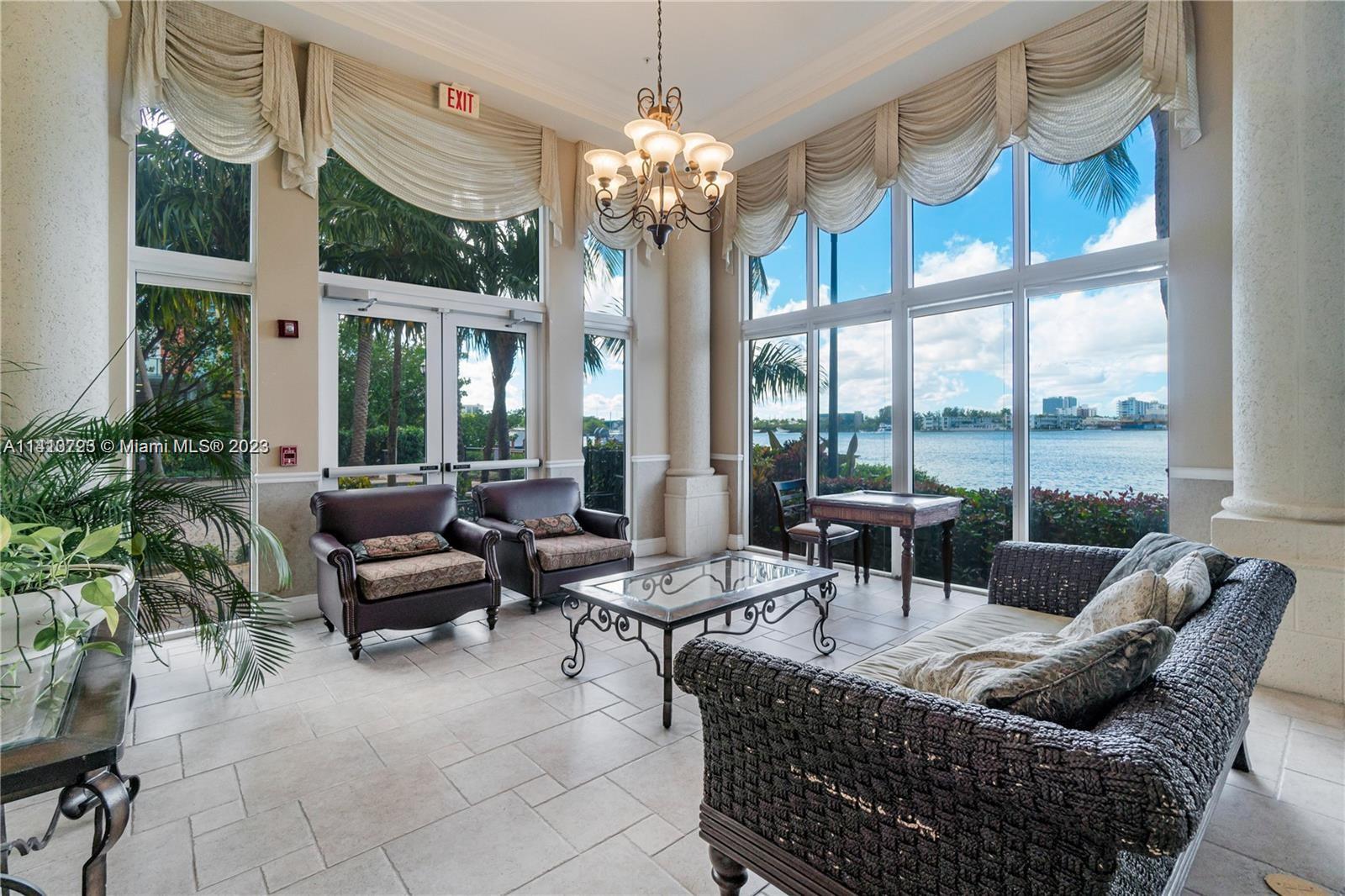 17100 North Bay Road, Unit 1613 Sunny Isles Beach, FL 33160 - Photo 14 of 30 a living room with patio furniture and a chandelier