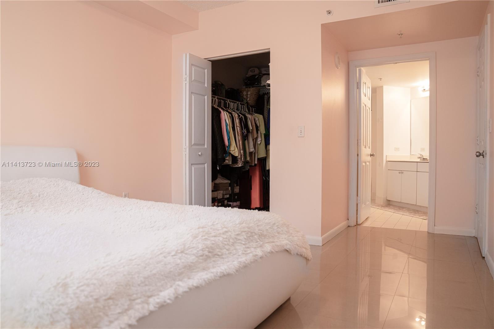 17100 North Bay Road, Unit 1613 Sunny Isles Beach, FL 33160 - Photo 20 of 30 a bed room with a bed and a walk in closet
