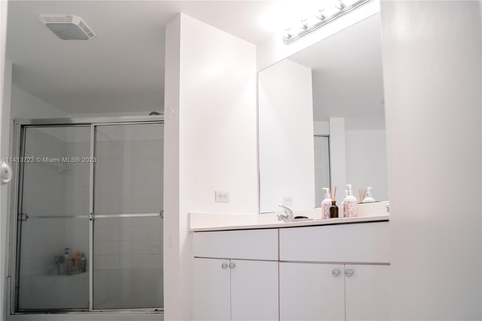 17100 North Bay Road, Unit 1613 Sunny Isles Beach, FL 33160 - Photo 21 of 30 a bathroom with a mirror and a sink