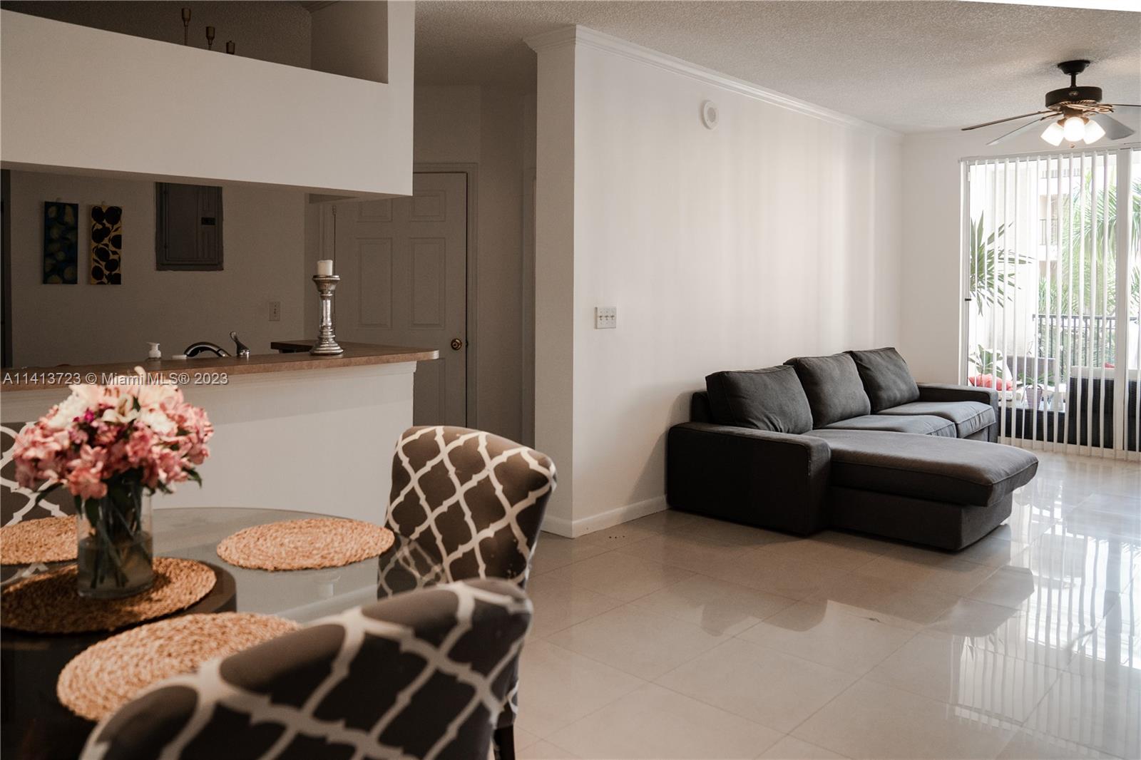 17100 North Bay Road, Unit 1613 Sunny Isles Beach, FL 33160 - Photo 22 of 30 a living room with furniture and flowers