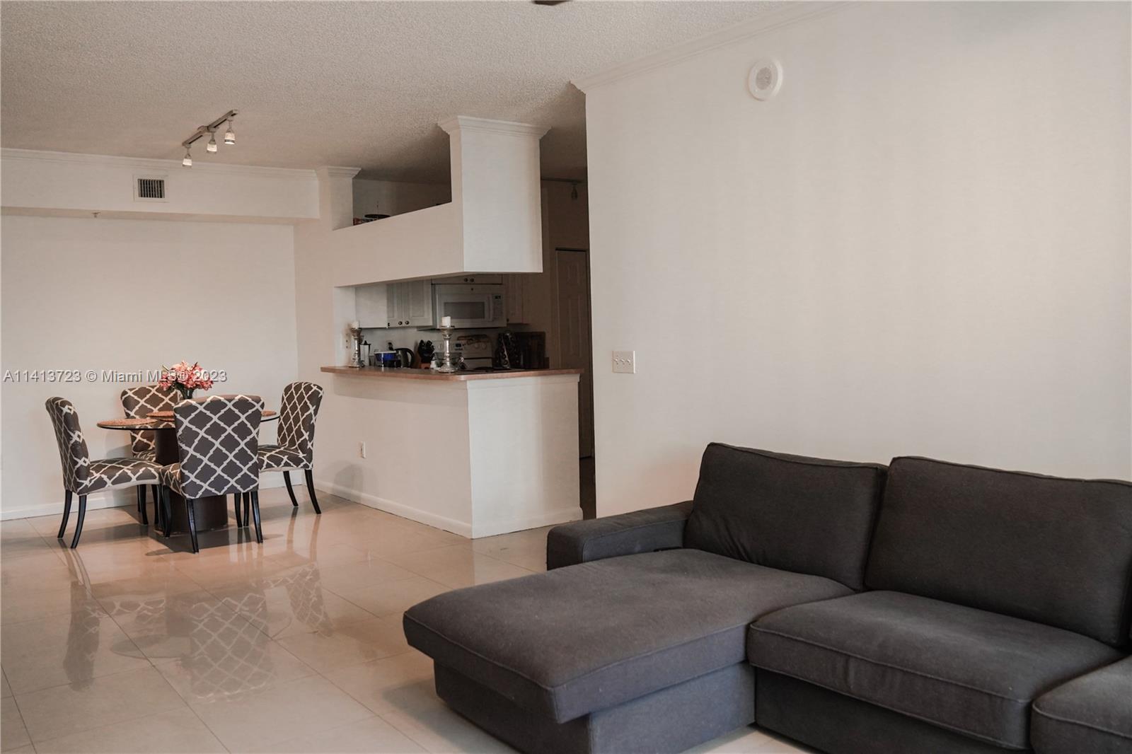 17100 North Bay Road, Unit 1613 Sunny Isles Beach, FL 33160 - Photo 23 of 30 a living room with furniture and kitchen view