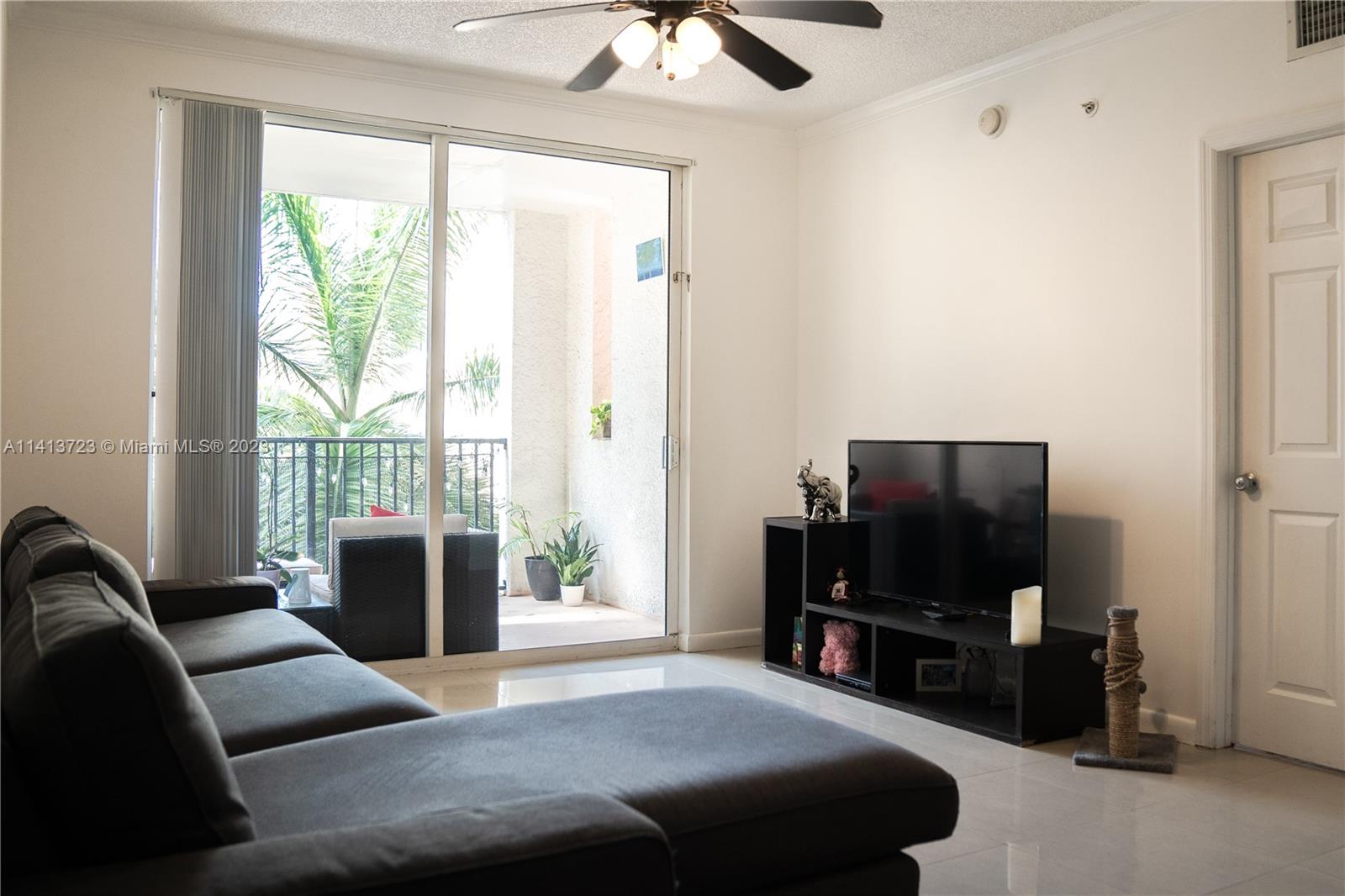 17100 North Bay Road, Unit 1613 Sunny Isles Beach, FL 33160 - Photo 24 of 30 a living room with furniture and a flat screen tv