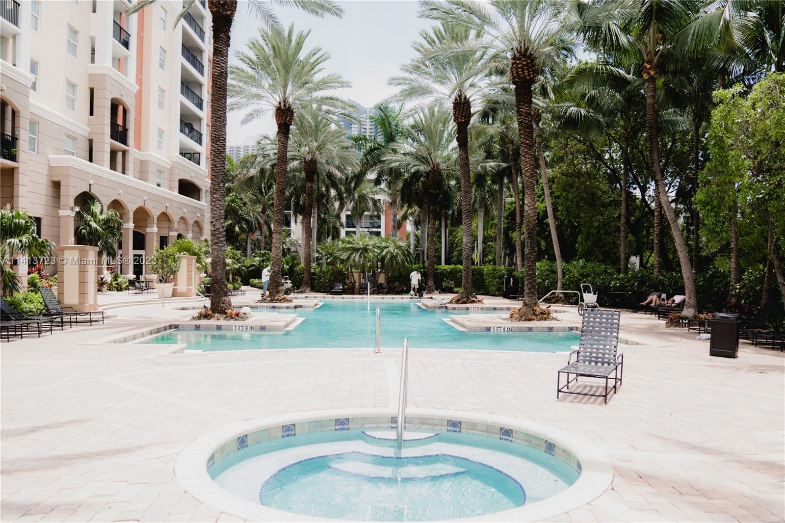 17100 North Bay Road, Unit 1613 Sunny Isles Beach, FL 33160 - Photo 28 of 30 a view of a swimming pool with palm trees