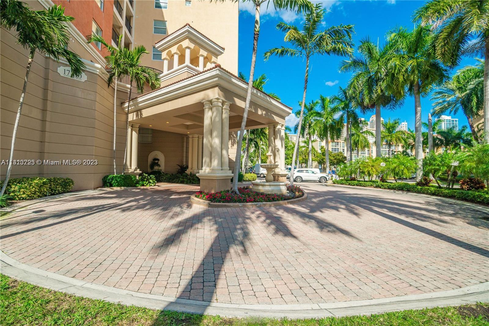 17100 North Bay Road, Unit 1613 Sunny Isles Beach, FL 33160 - Photo 9 of 30 a view of a brick building with plants and palm trees