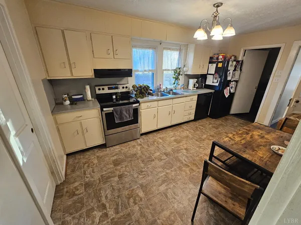 a kitchen with a table chairs stove and cabinets