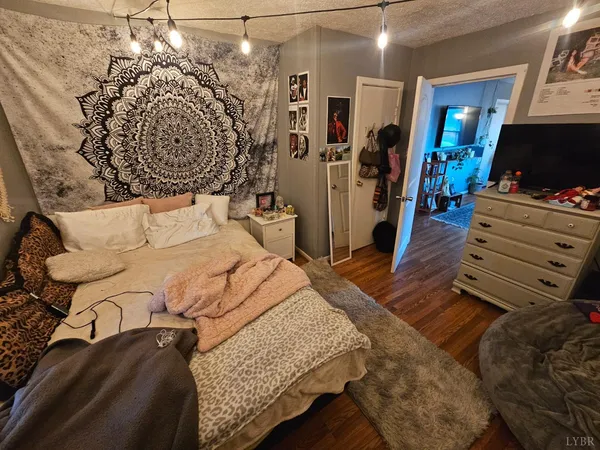 a bedroom with a bed closet and a flat tv screen