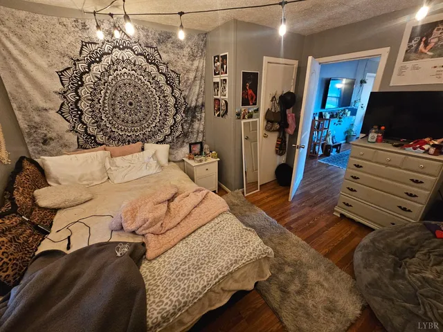 a bedroom with a bed closet and a flat tv screen