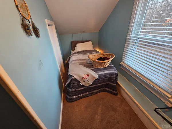 a bedroom with a bed and dresser