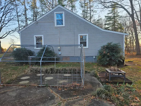 a view of dirt yard with a large tree