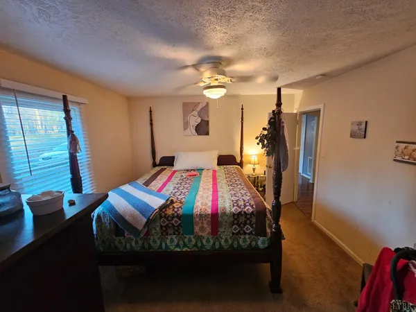 a bed sitting in a bedroom next to a window