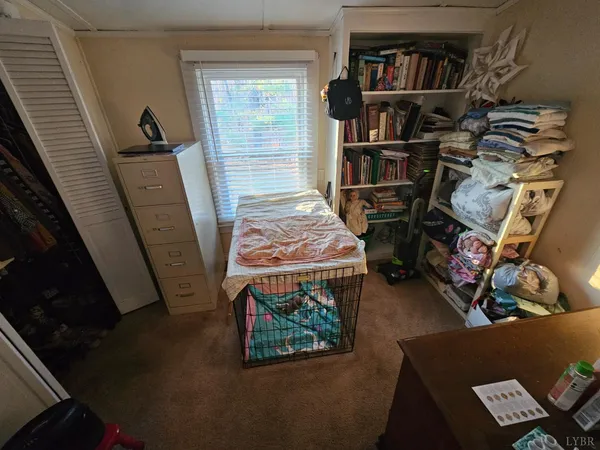 a room with lots of books and a book shelf