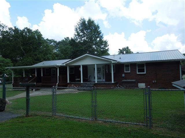 232 Daniel Road Dover, TN 37058 - Photo 5 of 20 Nice back covered patio and covered deck, sidewalk out to the driveway.