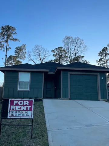 a view of a house with a yard and garage