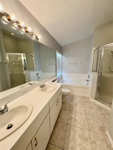 a spacious bathroom with a sink a mirror and a bathtub